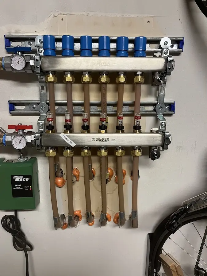 Plumber performing Water Heater Repair at a residential property in Fort Lewis